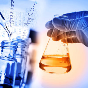 Flask in scientist hand with laboratory background